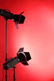 Photo of Red photo background and professional lighting equipment in studio