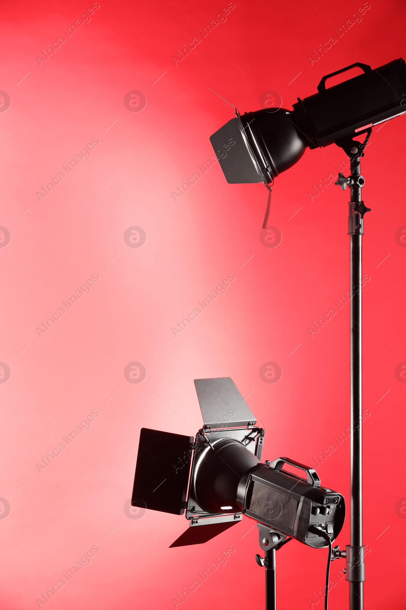 Photo of Red photo background and professional lighting equipment in studio