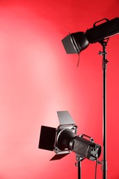 Red photo background and professional lighting equipment in studio