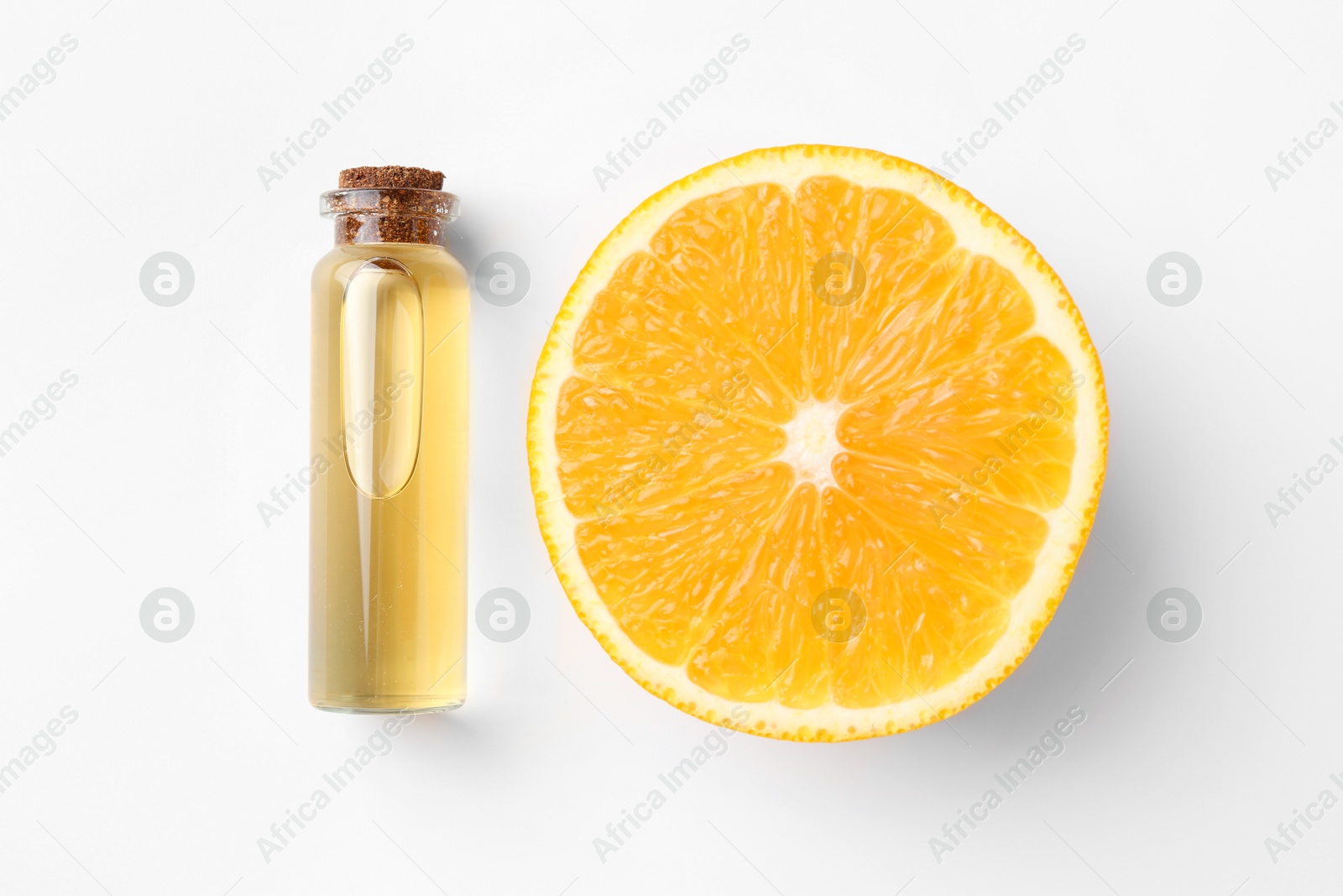 Photo of Bottle of essential oil and orange on white background, top view