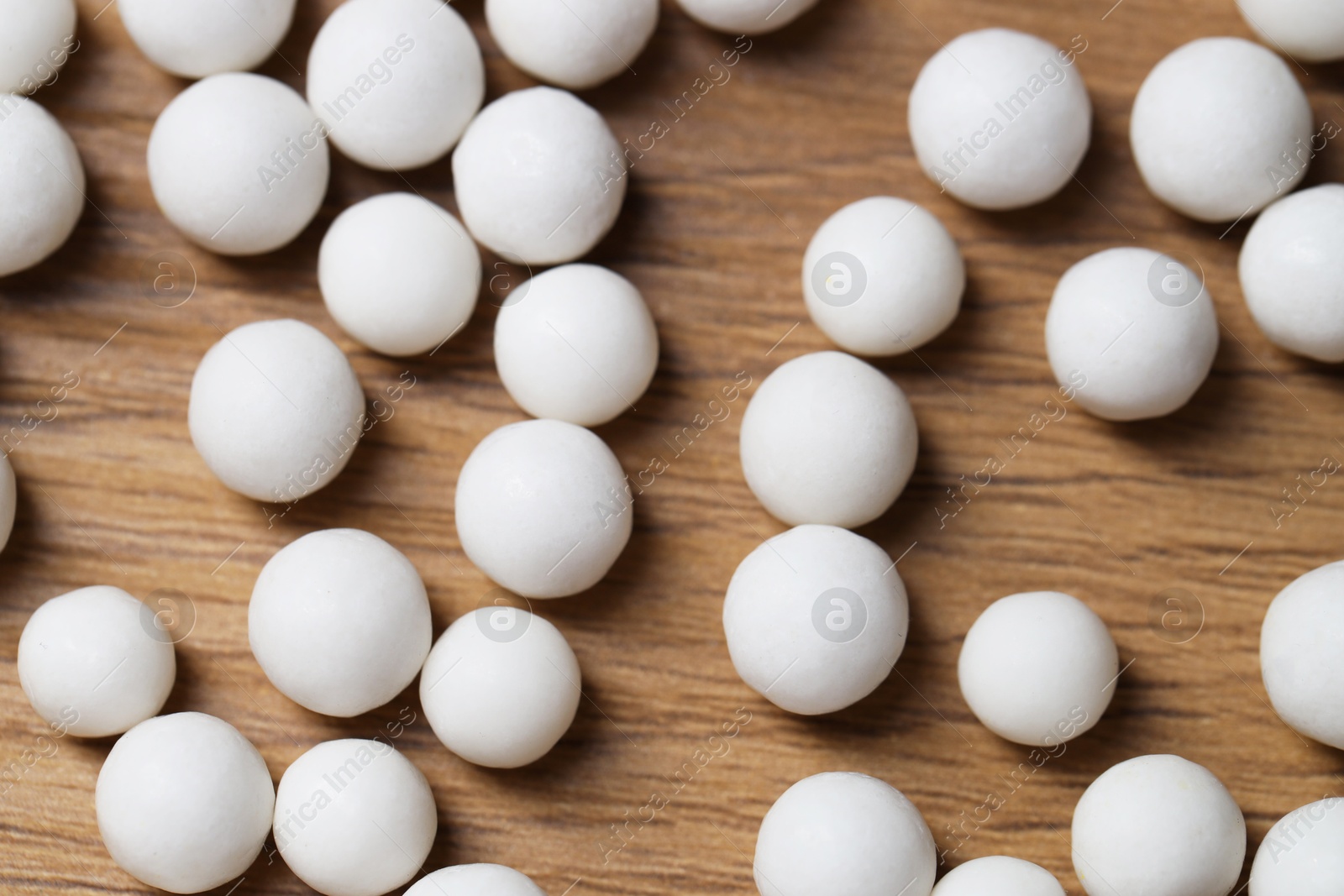 Photo of Homeopathy medicine. Many pills on wooden table