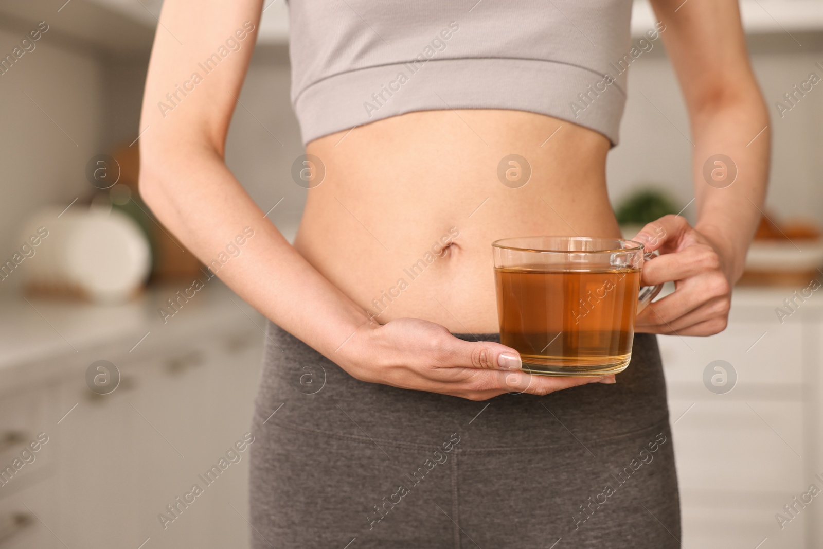 Photo of Weight loss concept. Woman with cup of diet tea indoors, closeup