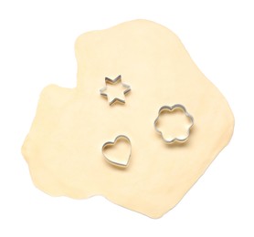 Photo of Raw dough and cookie cutters isolated on white, top view