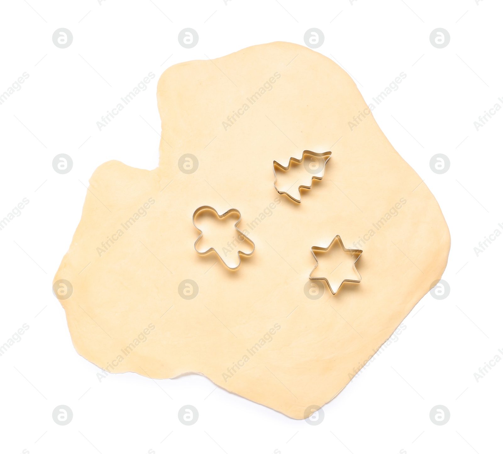 Photo of Raw dough and cookie cutters isolated on white, top view