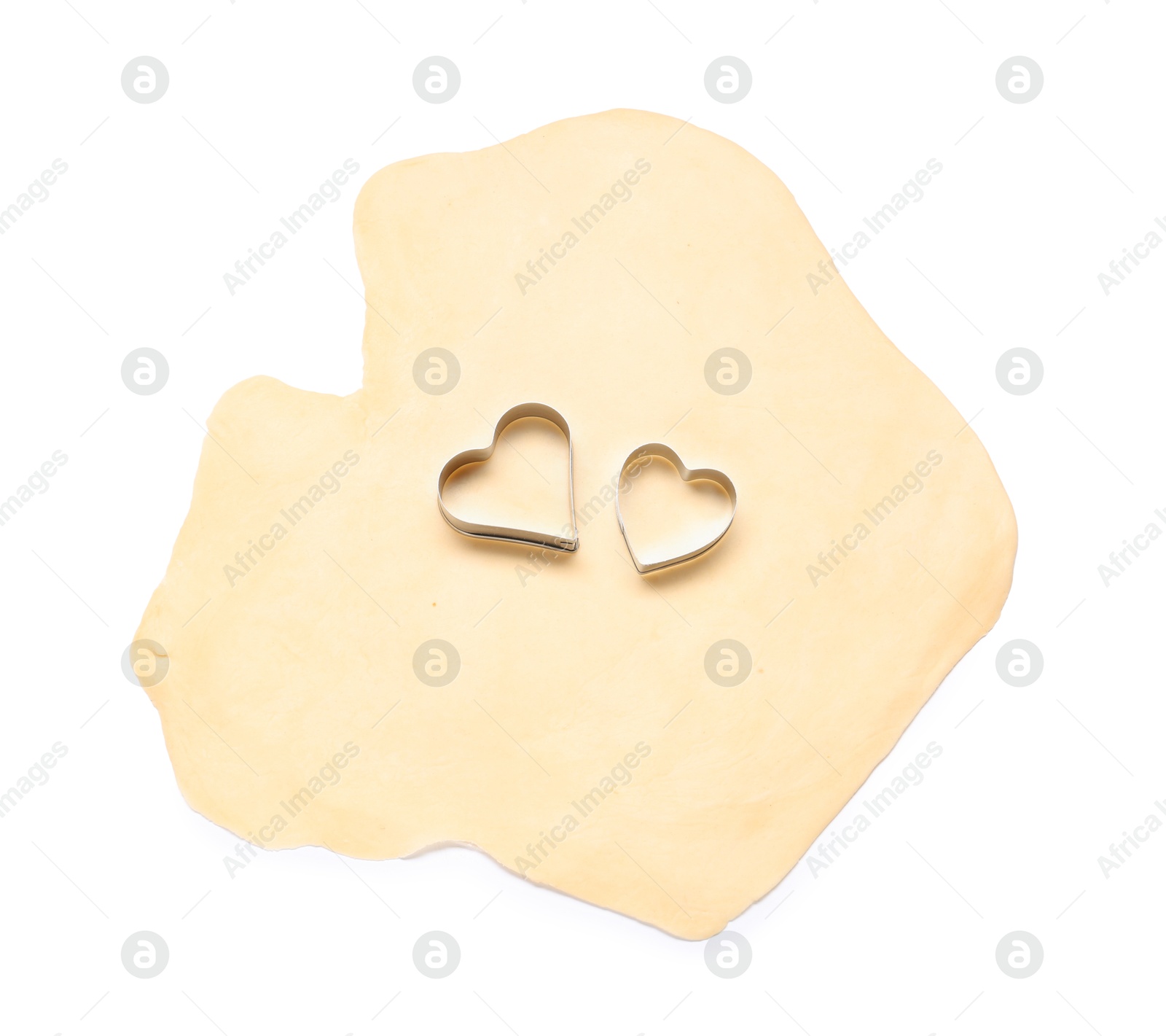 Photo of Raw dough and cookie cutters isolated on white, top view