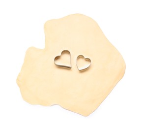 Photo of Raw dough and cookie cutters isolated on white, top view