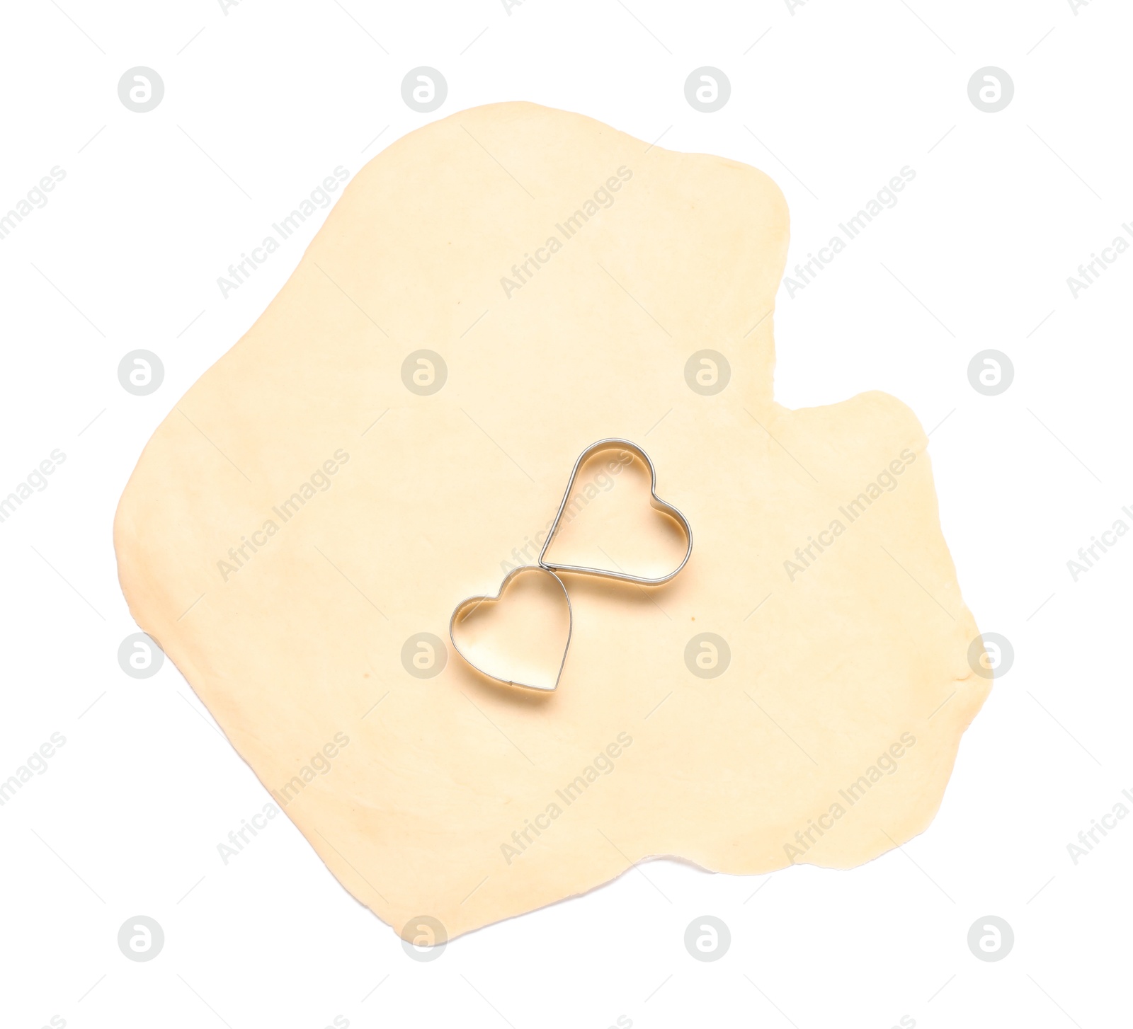 Photo of Raw dough and cookie cutters isolated on white, top view