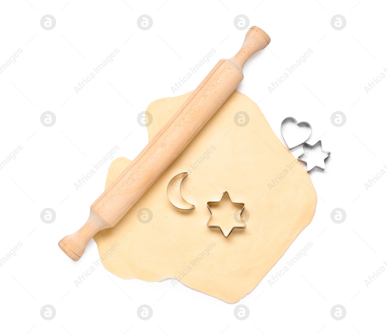 Photo of Raw dough, wooden rolling pin and cookie cutters isolated on white, top view