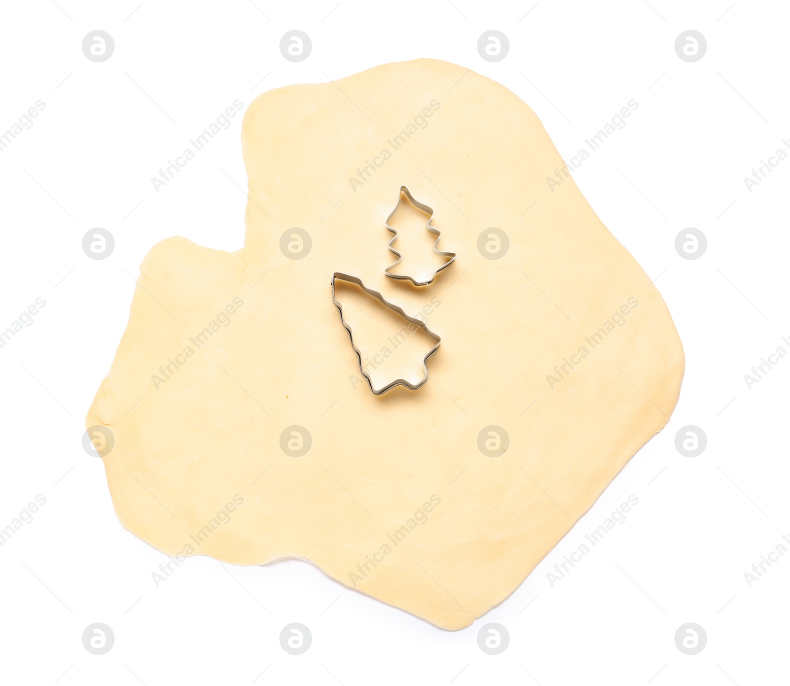 Photo of Raw dough and cookie cutters isolated on white, top view