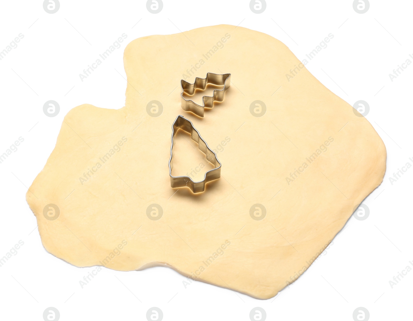 Photo of Raw dough and cookie cutters isolated on white