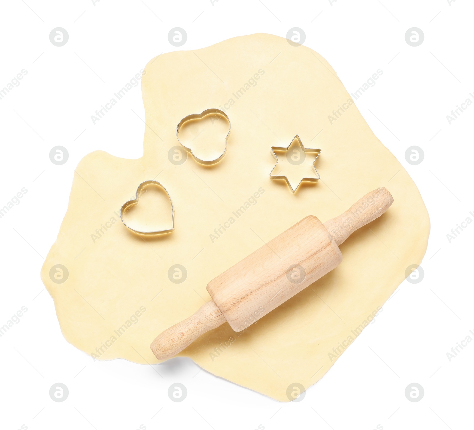 Photo of Raw dough, wooden rolling pin and cookie cutters isolated on white, top view