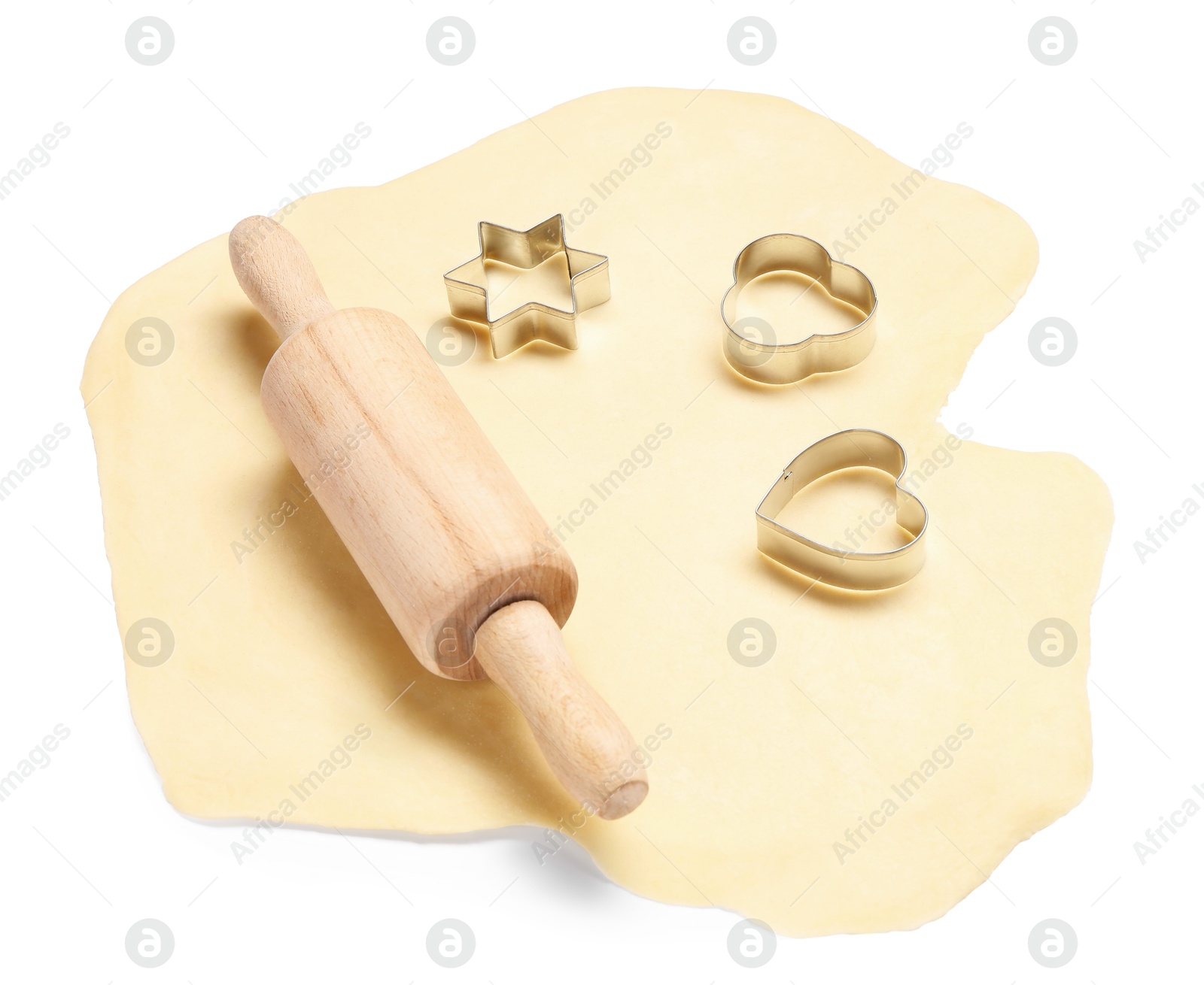 Photo of Raw dough, wooden rolling pin and cookie cutters isolated on white