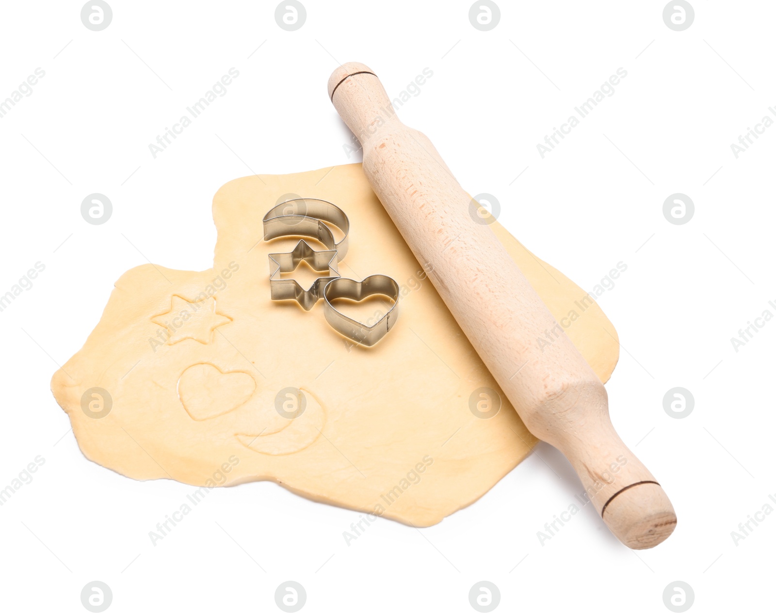 Photo of Raw dough, wooden rolling pin and cookie cutters isolated on white