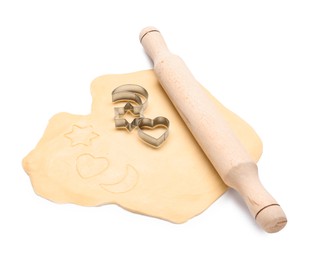 Photo of Raw dough, wooden rolling pin and cookie cutters isolated on white