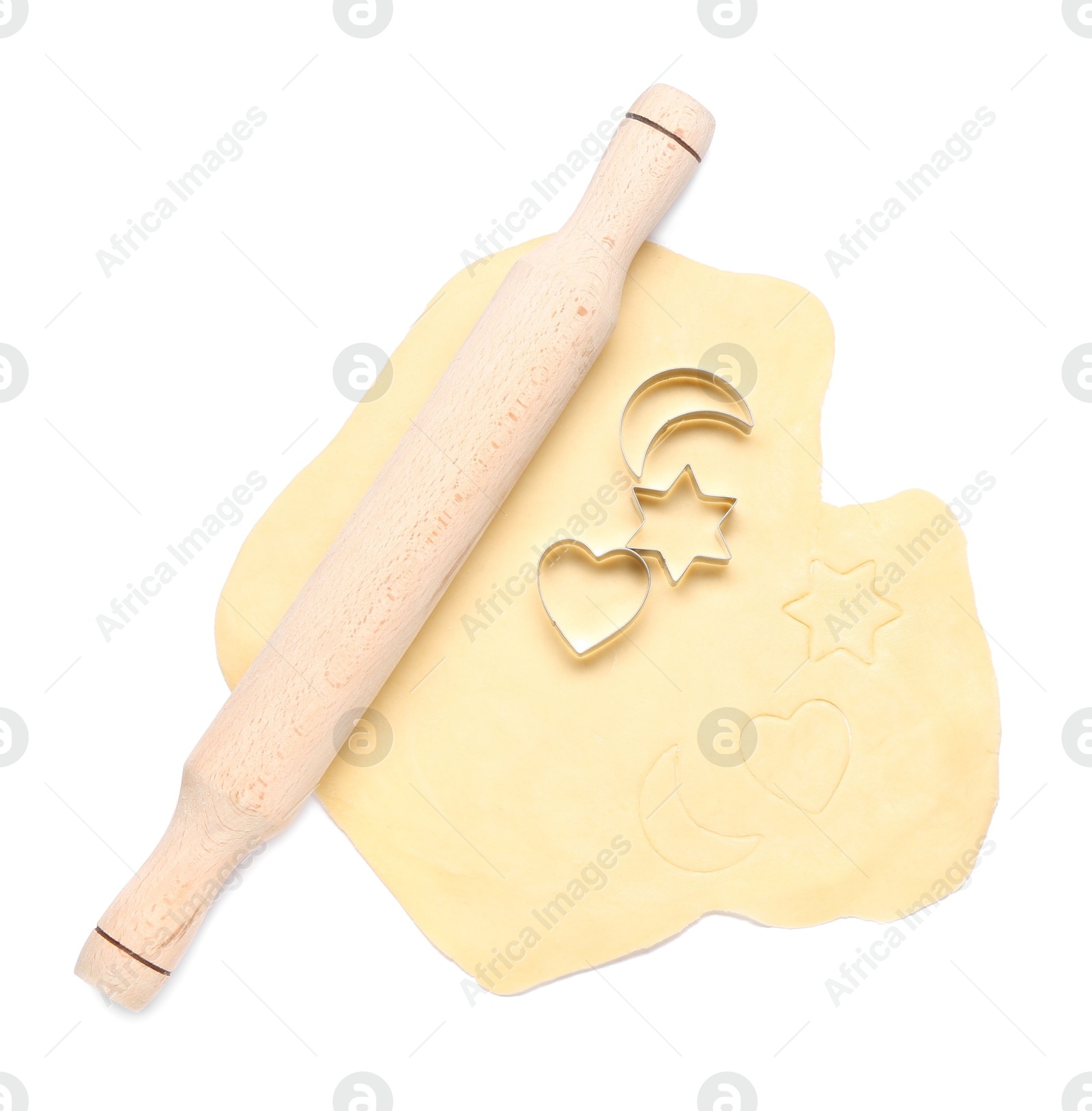 Photo of Raw dough, wooden rolling pin and cookie cutters isolated on white, top view