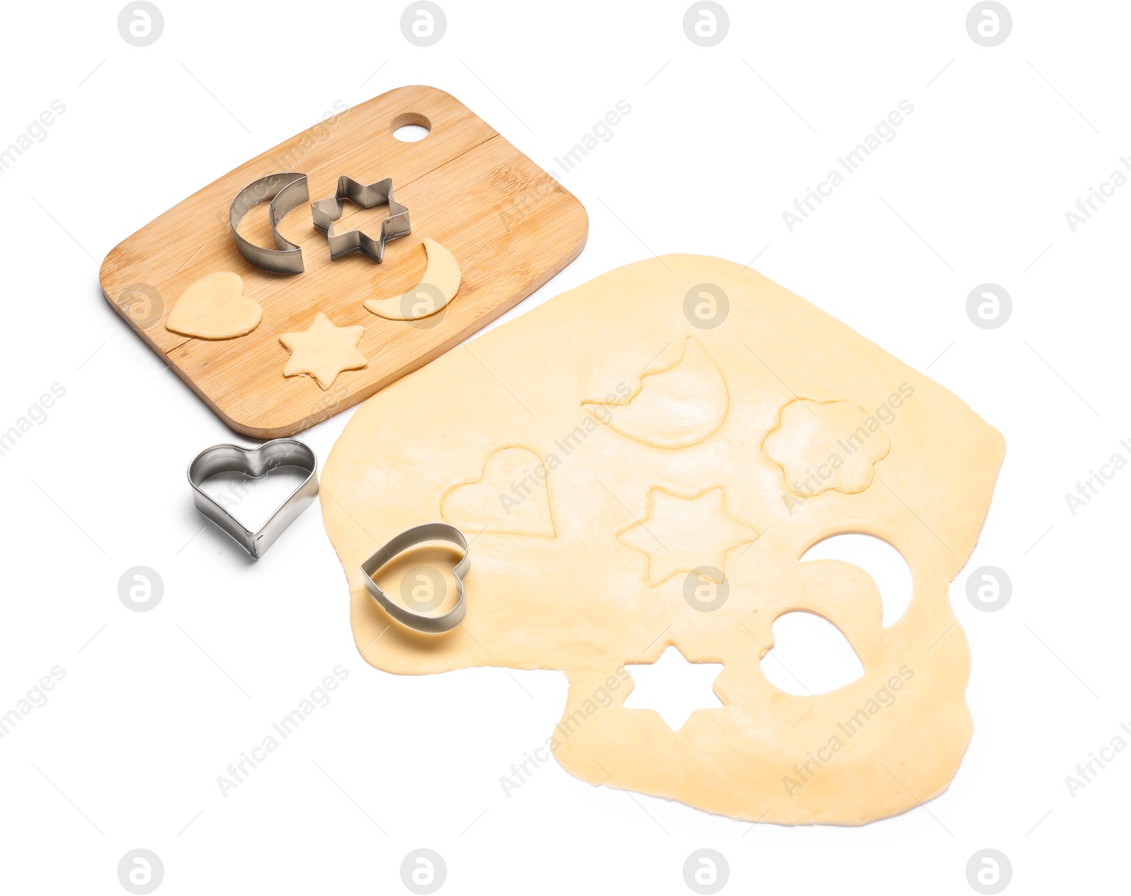 Photo of Raw dough, wooden board and cookie cutters isolated on white