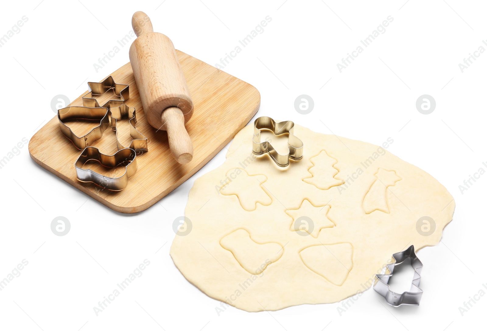 Photo of Raw dough, rolling pin, cookie cutters and board isolated on white