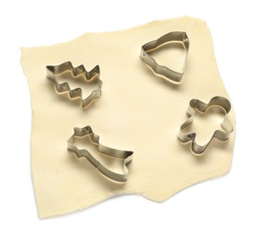 Photo of Raw dough and cookie cutters isolated on white, above view