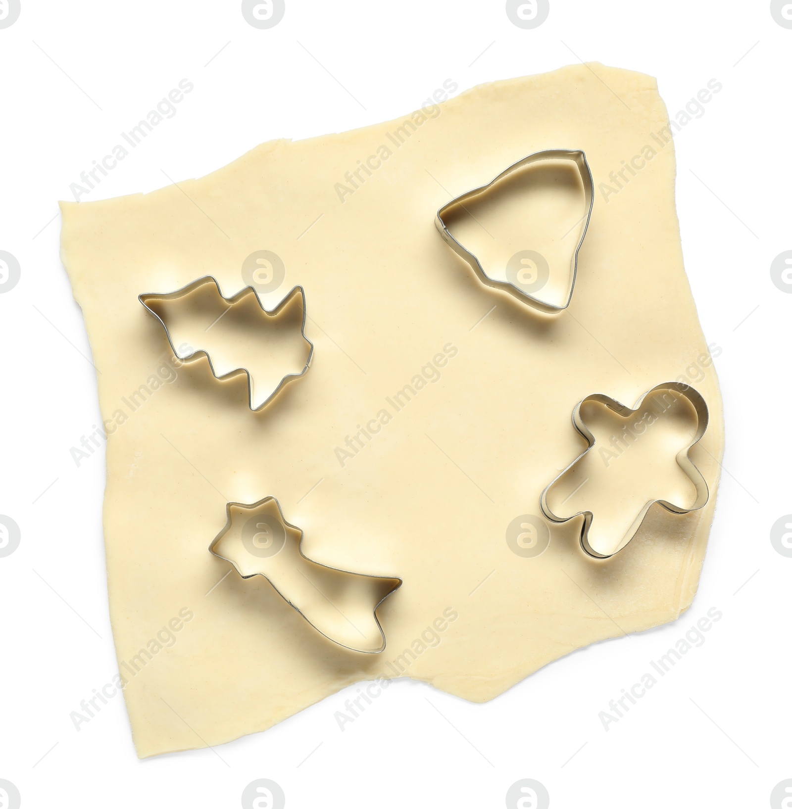 Photo of Raw dough and cookie cutters isolated on white, top view