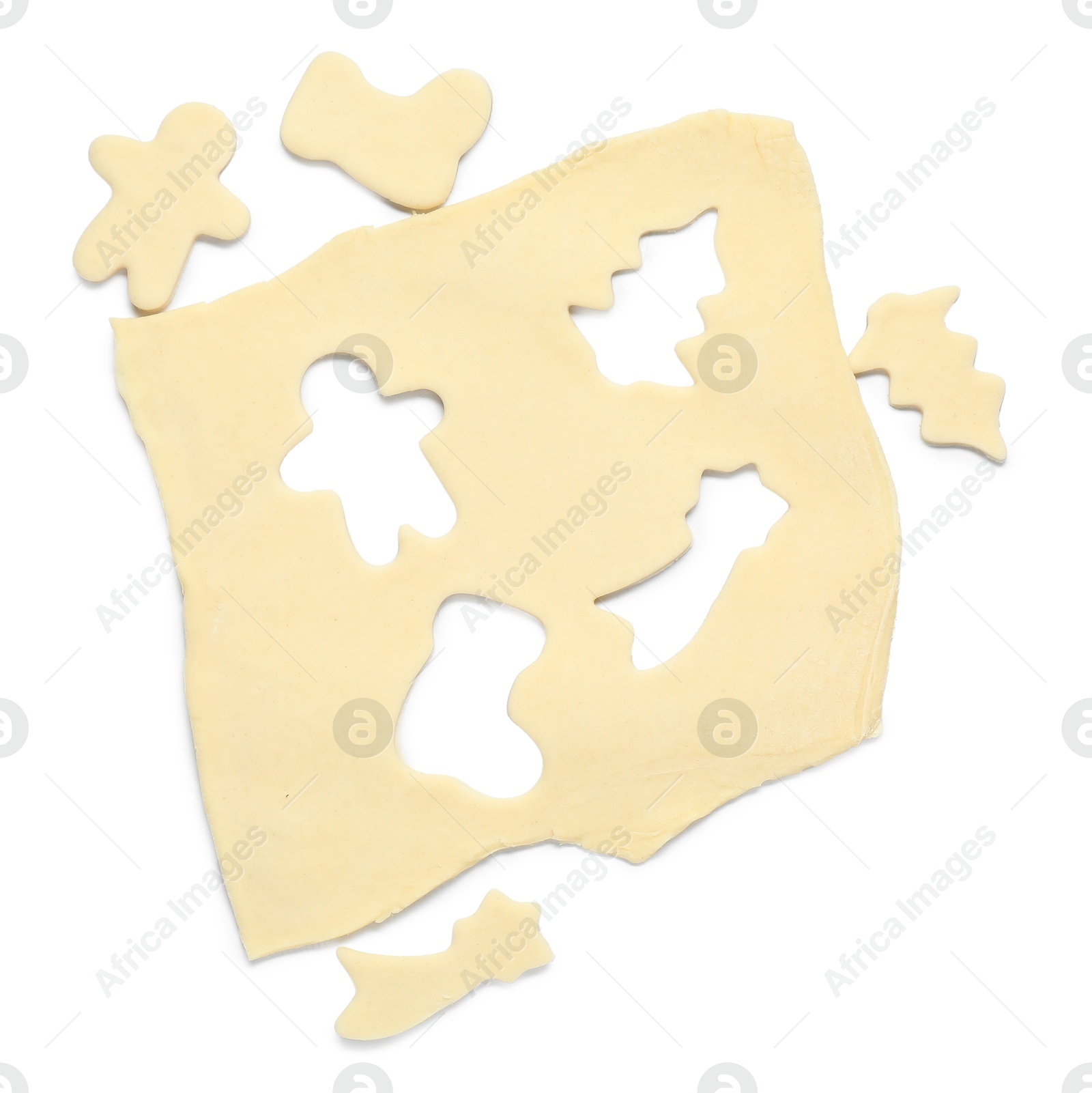 Photo of Raw dough and uncooked cookies in different shapes isolated on white, top view