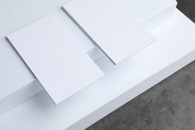 Photo of Blank business cards on grey textured table. Mockup for design