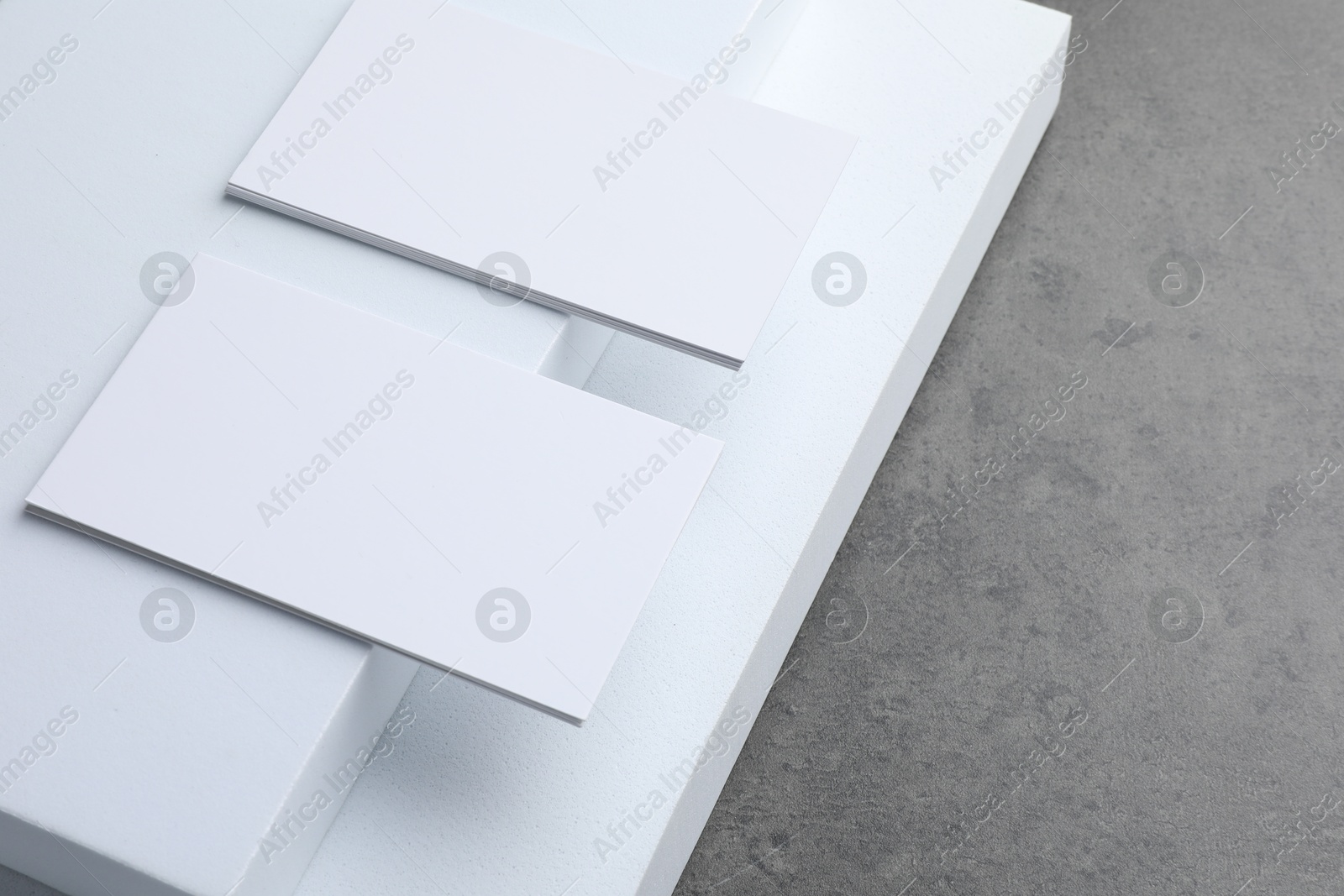 Photo of Blank business cards on grey textured table. Mockup for design