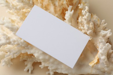 Blank business card on beige background, top view. Mockup for design