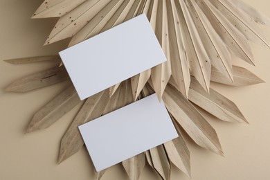 Photo of Blank business cards on beige background, flat lay. Mockup for design