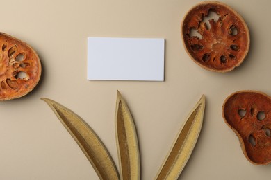 Blank business cards and dried products on beige background, flat lay. Mockup for design