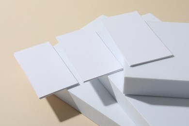 Blank business cards on beige background. Mockup for design