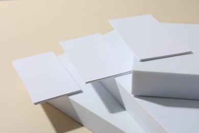 Blank business cards on beige background. Mockup for design