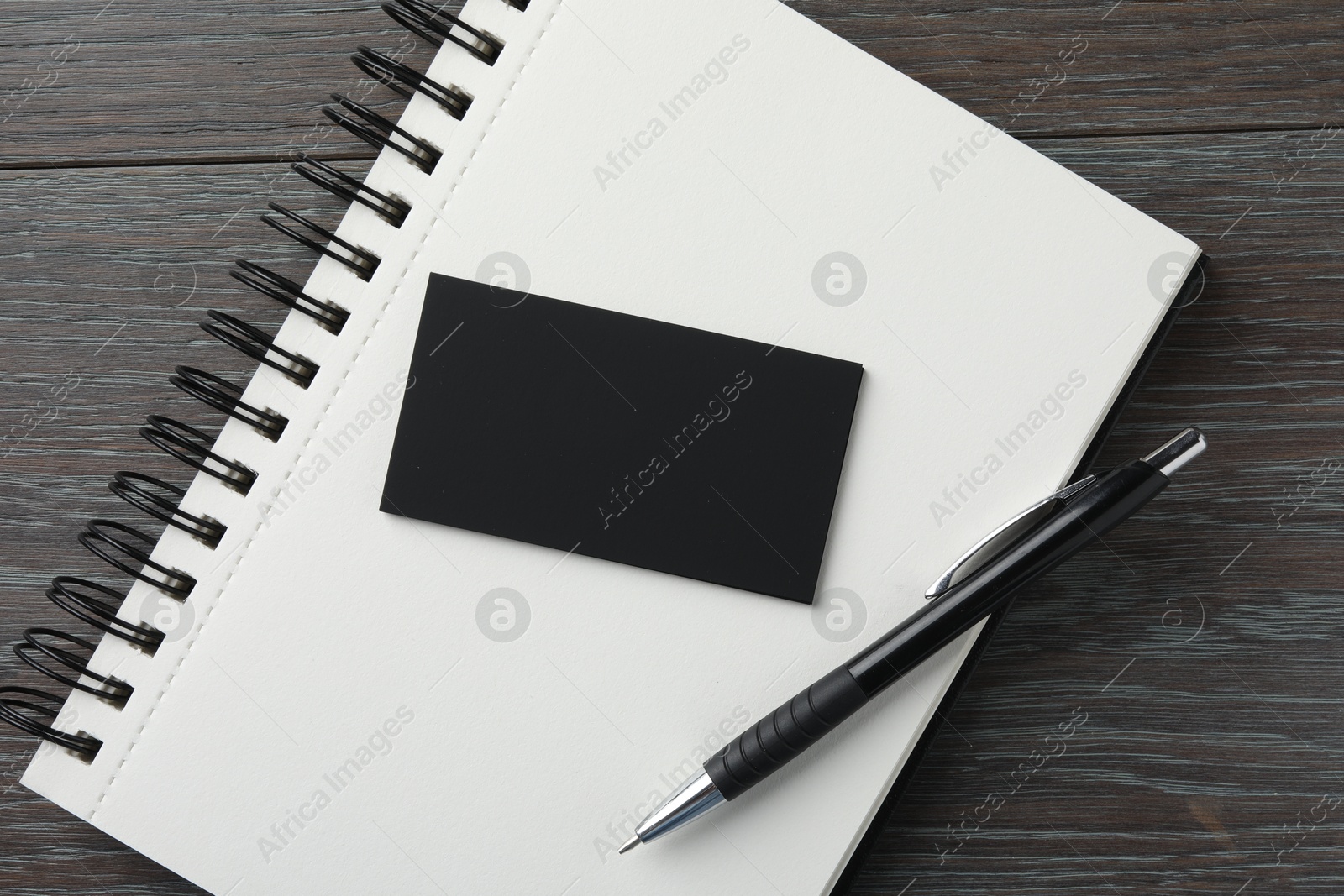 Photo of Blank business cards, notebook and pen on wooden table, flat lay. Mockup for design