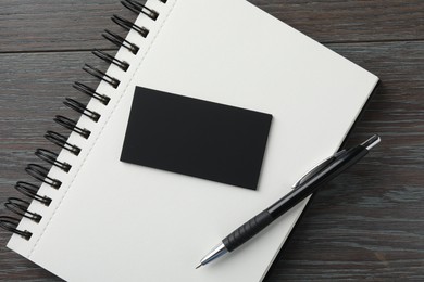 Blank business cards, notebook and pen on wooden table, flat lay. Mockup for design