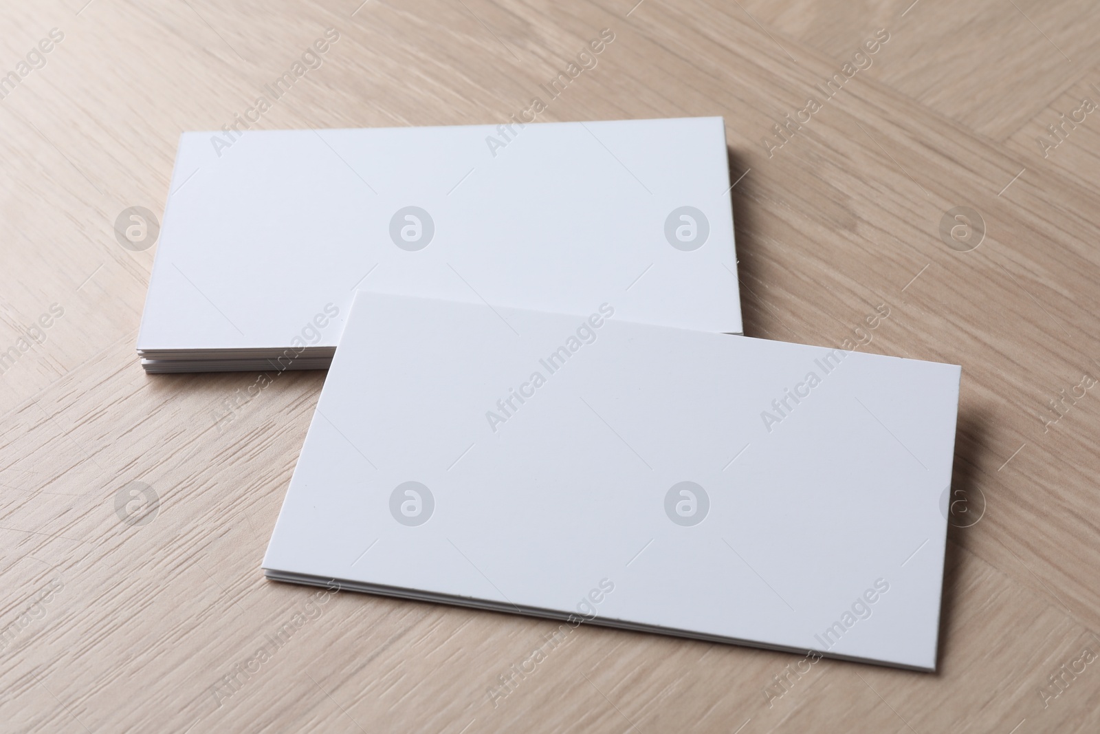 Photo of Blank business cards on wooden table. Mockup for design