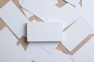 Blank business cards on wooden table, flat lay. Mockup for design