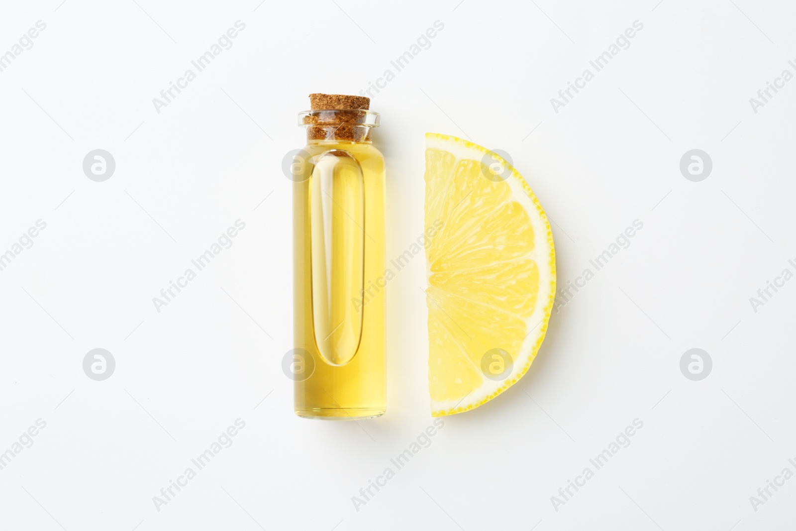 Photo of Bottle of essential oil and lemon on white background, top view