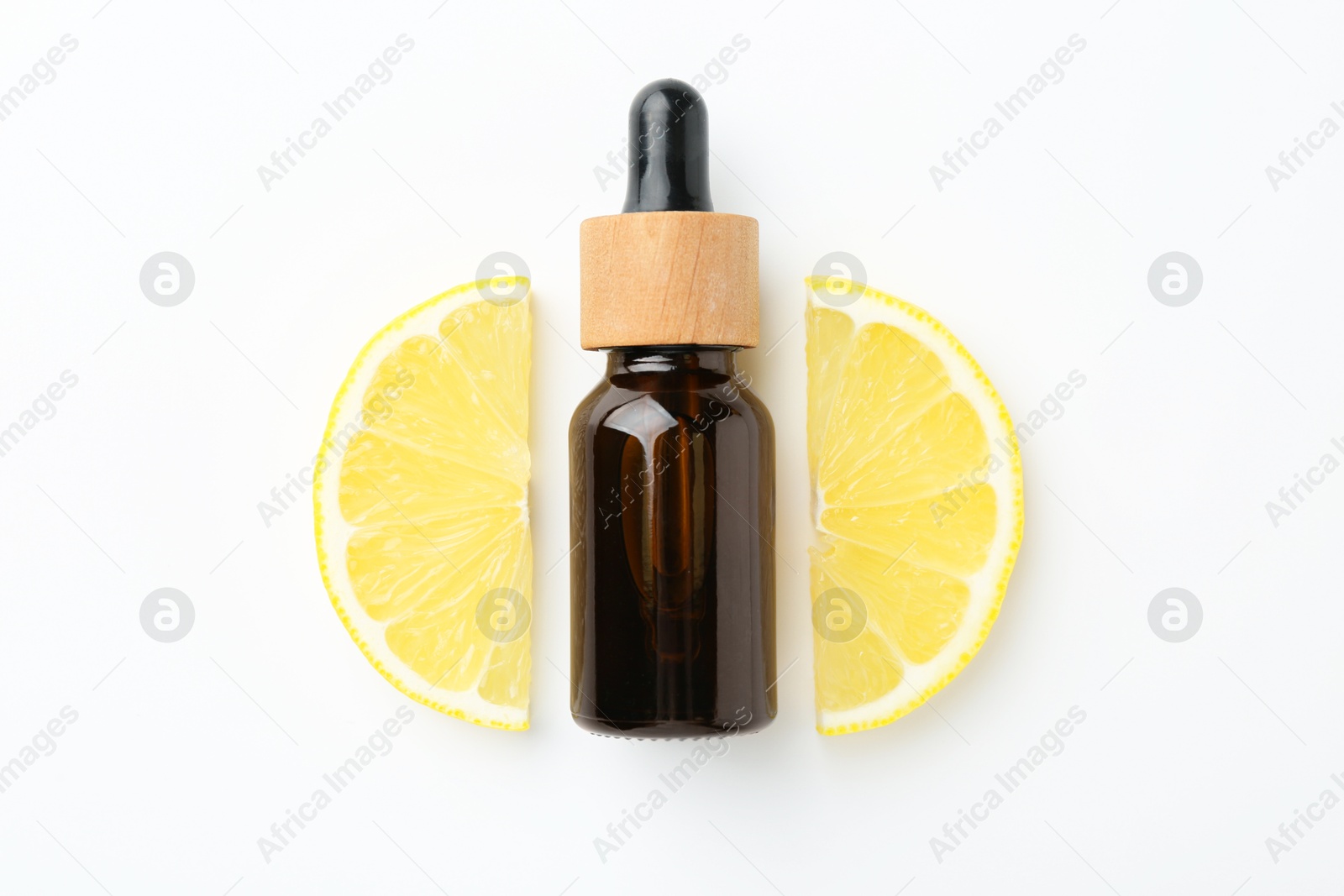 Photo of Bottle of essential oil and lemon on white background, top view