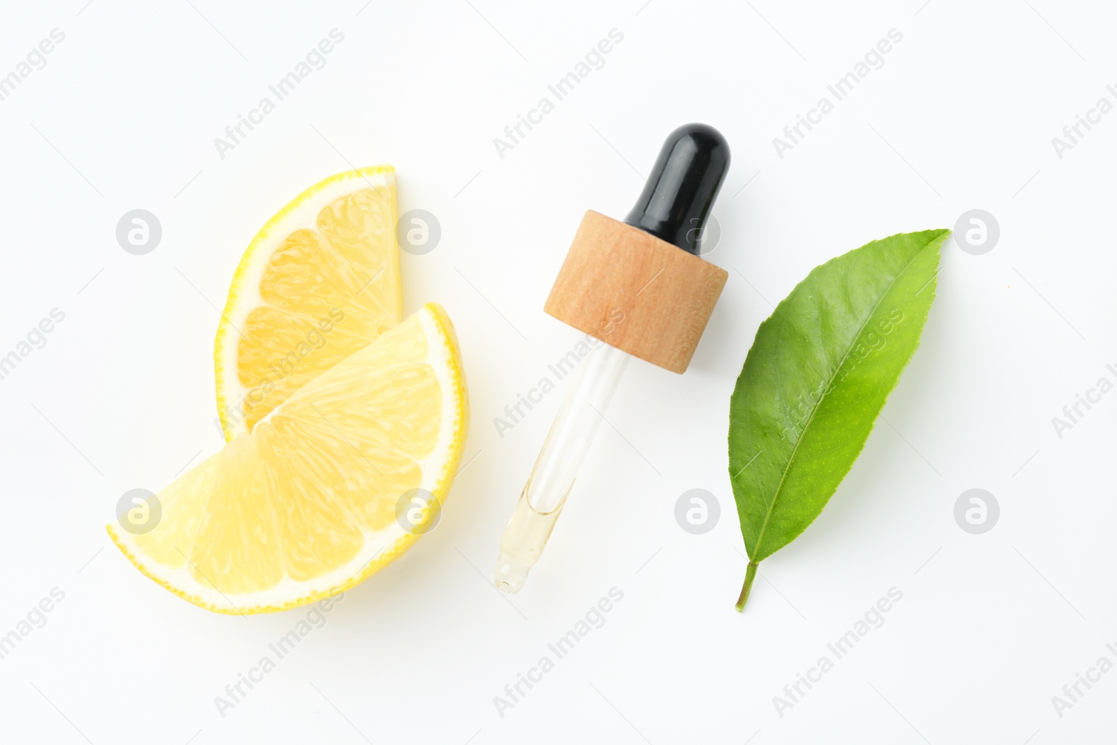 Photo of Pipette of essential oil, lemon and green leaf on white background, flat lay