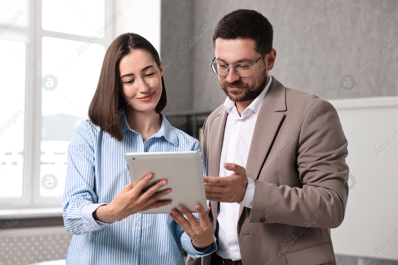 Photo of Young consultant working with client in office