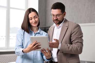 Young consultant working with client in office