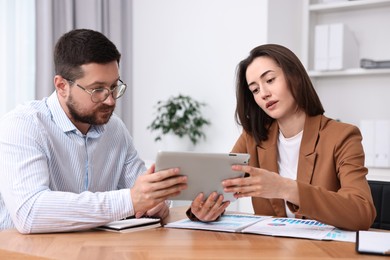 Consultant working with client at table in office