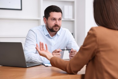 Consultant working with client at table in office