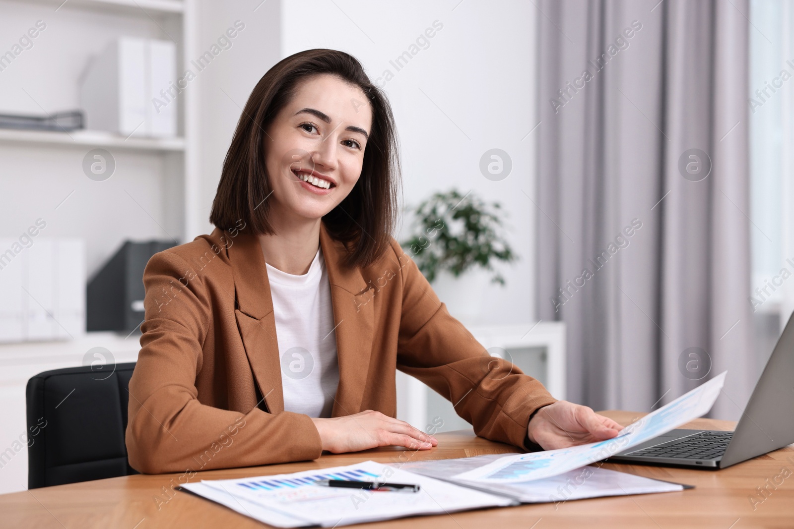 Photo of Consultant working with documents at table in office