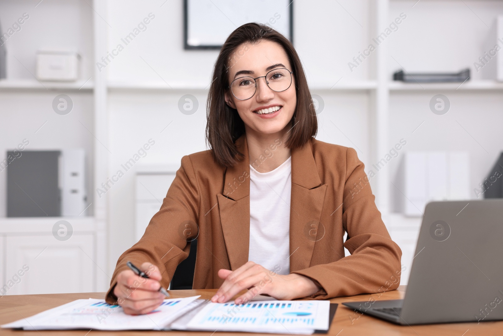 Photo of Consultant working with documents at table in office