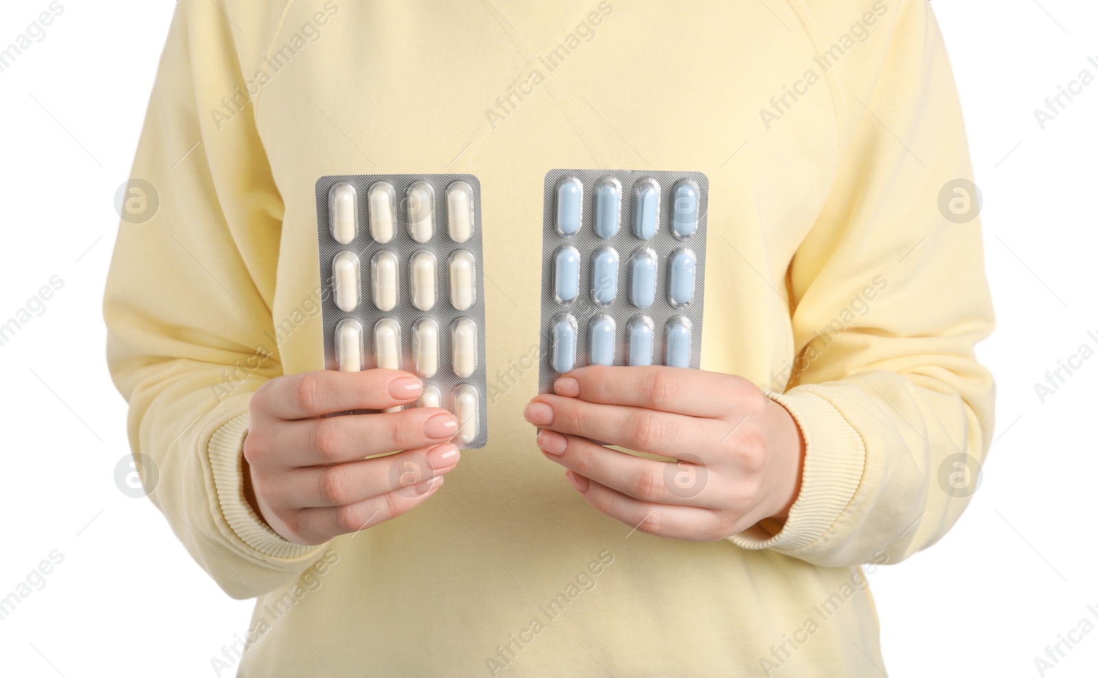 Photo of Woman holding blisters with antibiotic pills on white background, closeup