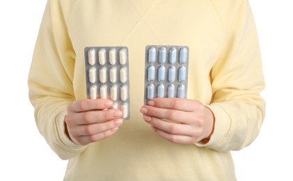 Photo of Woman holding blisters with antibiotic pills on white background, closeup