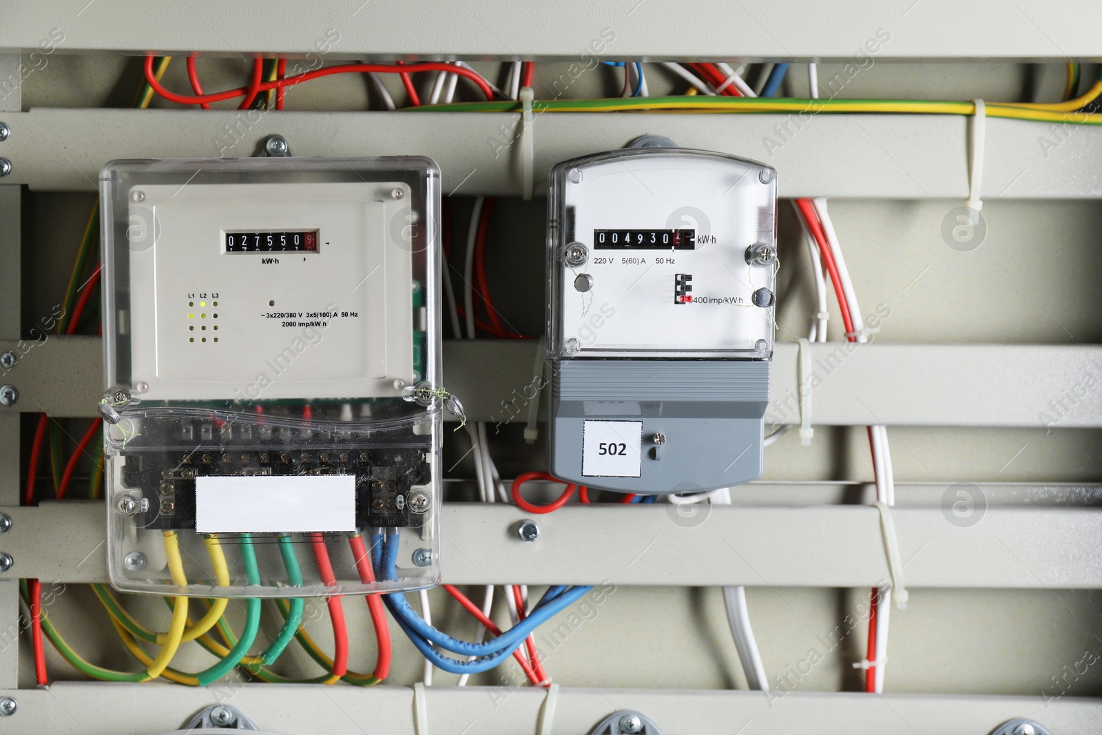 Photo of Electric meters and wires in fuse box. Energy measuring device