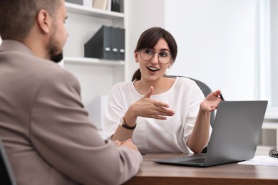 Consultant working with client at table in office. Business meeting