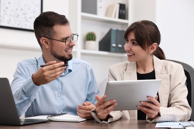 Consultant working with client at table in office. Business meeting