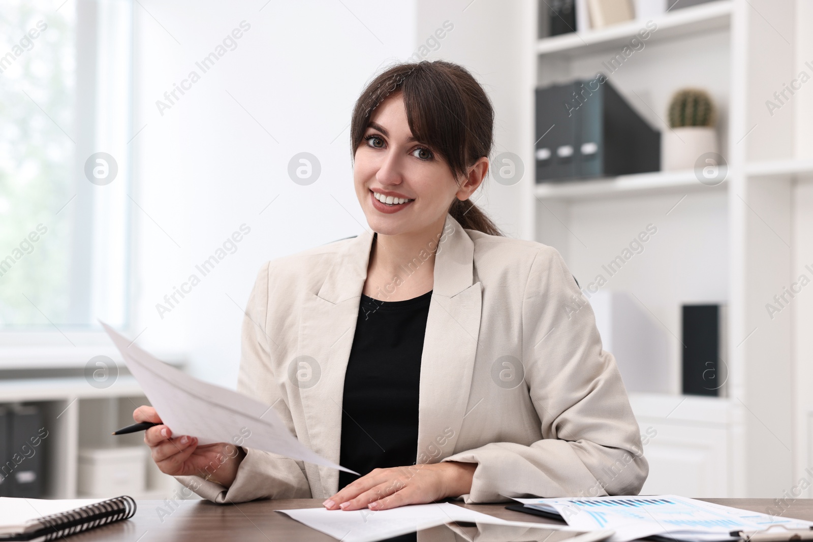 Photo of Portrait of smiling business consultant at table in office